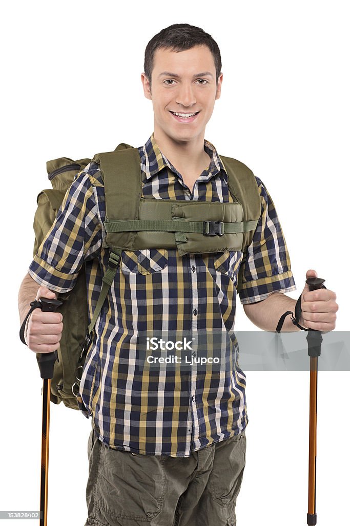 Sonriente hombre con mochila y excursionismo polos - Foto de stock de Actividad libre de derechos