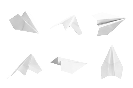 White paper airplanes are photographed from various angles.