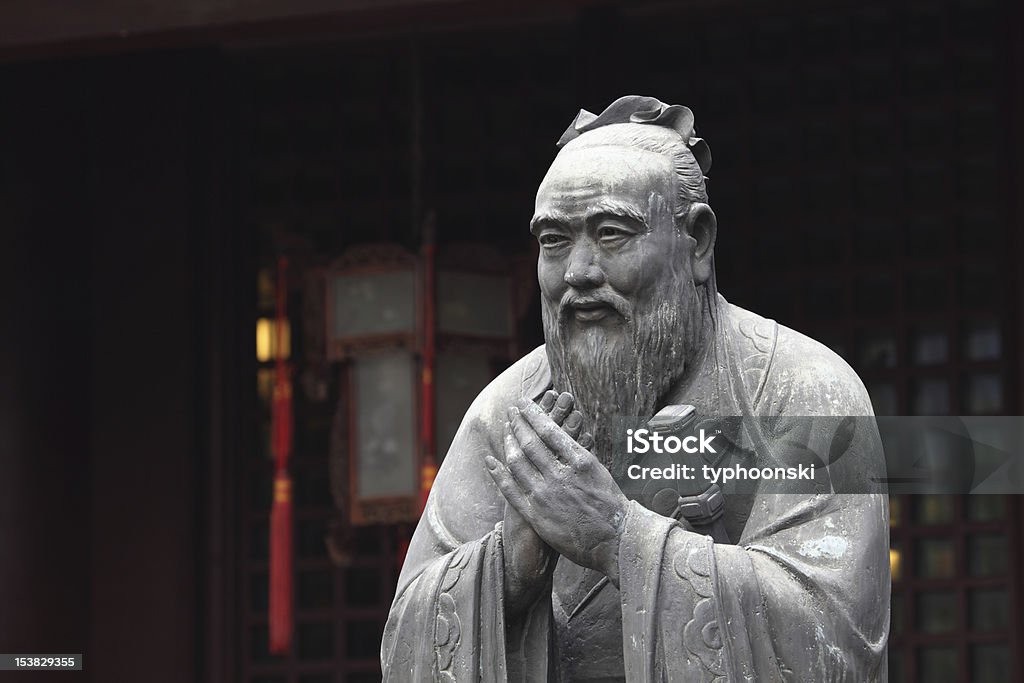 Freestanding, grey stone statue of Confucius outside temple Statue of Confucius at Confucian Temple in Shanghai, China Confucius Stock Photo