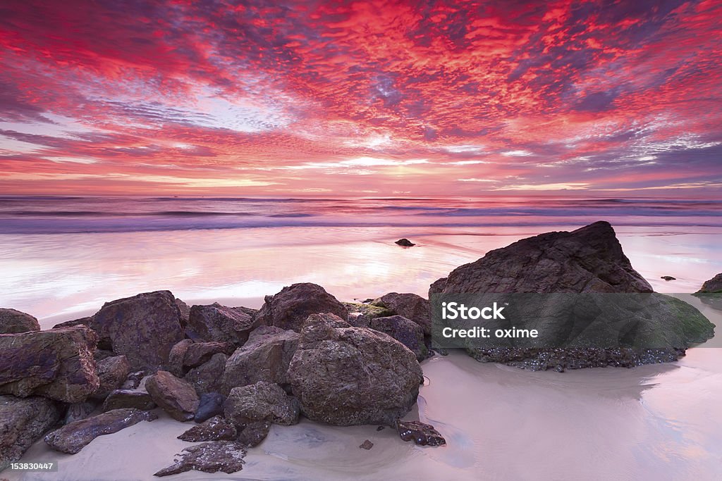 australian seascape at sunrise with rich in red color australian seascape at sunrise with rich in red color cloud formation (miami beach,queensland,australia) Australia Stock Photo