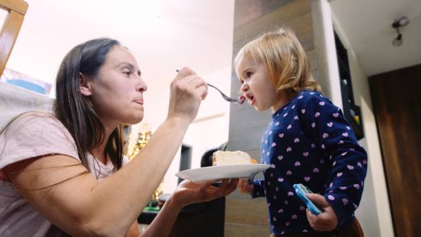 istock Child eating birthday cake. 1538313335
