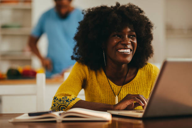 istock A happy interracial woman is using a laptop for remote work from home. 1538320870