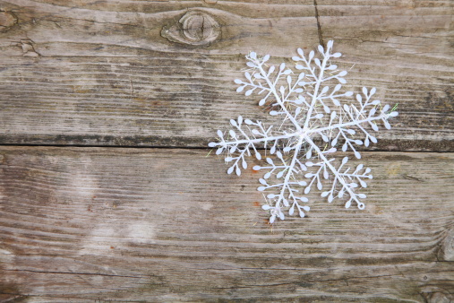 Christmas decorations (snowflake) on a wooden background