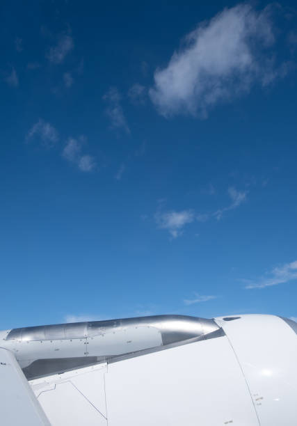 istock Airplane in flight. People travelling. Aerial view from plane window. Blue sky above clouds 1538325871