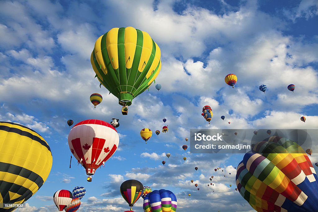 Hot air balloons flying through the sky Colorful variety of hot air balloons in flight. Adventure Stock Photo