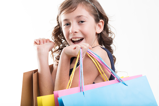 oyful girl with colorful shopping bags indulges in the thrill of spending