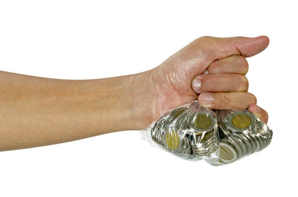 istock Hand holding coins in plastic bag isolated on white background,include clipping path 1538542193