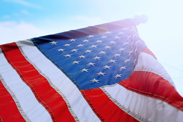 istock American Flag in sunny sky 153857736