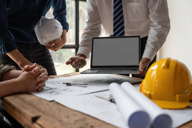 istock engineer team working in office with blueprints, inspection in workplace for architectural plan, construction project ,Business construction 1538622907