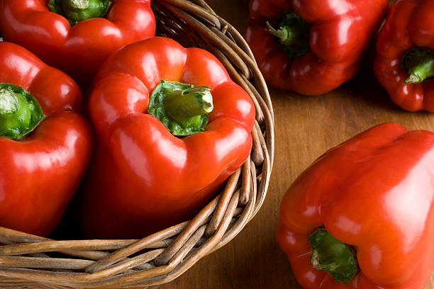 basket with fresh peppers bodegon basket with fresh red peppers red bell pepper stock pictures, royalty-free photos & images