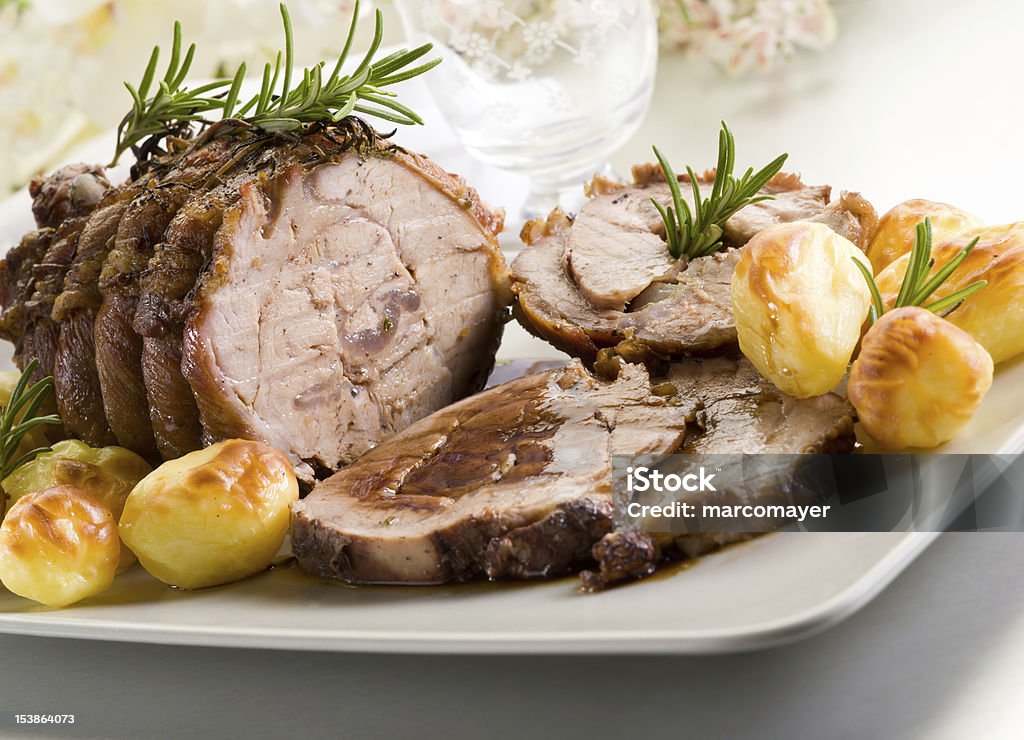 Roast of veal with potatoes on a white plate roast of veal with potatoes Roasted Stock Photo