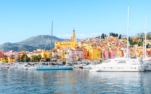 Menton, France - Panorama view of village with colorful houses on the French Riviera, Cote D Azur - View from the marina on the Mediterranean Sea.