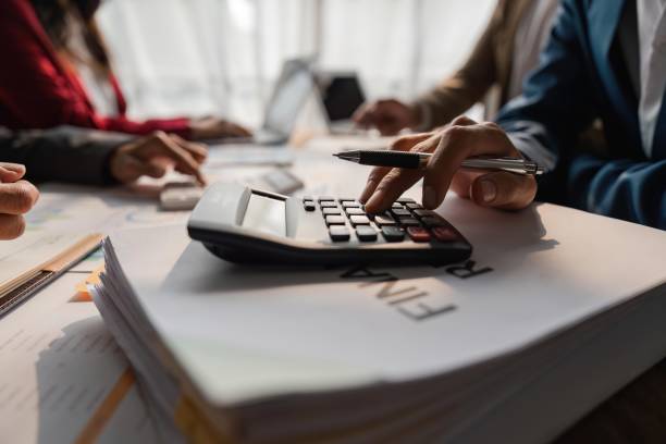 istock Business team meeting using calculator Work with charts and analyze business strategies. financial statistics sitting at the desk 1538663264