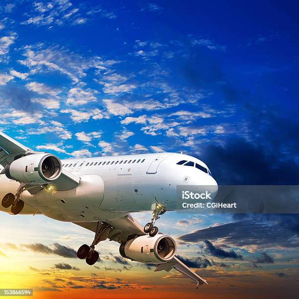 Jet Plane In A Sunset Sky Stock Photo - Download Image Now - Air Vehicle, Airplane, Commercial Airplane