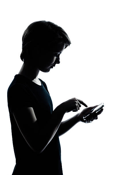 istock A teenager playing on smartphone in dark lighting 153867026