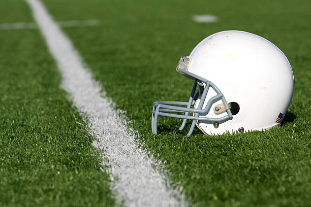American Football Helmet on Field stock photo