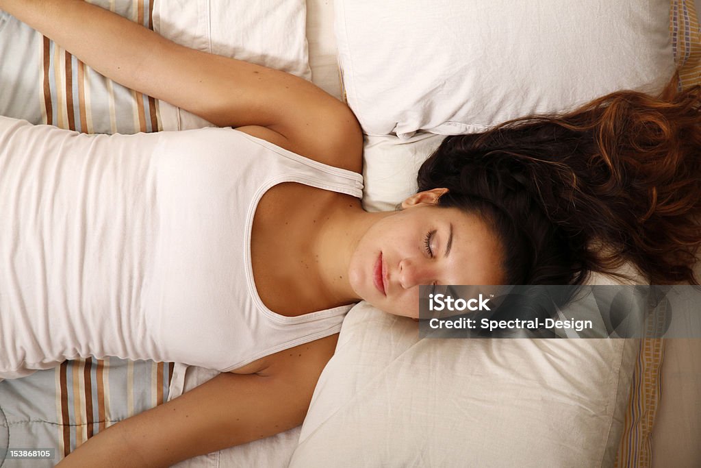 Relaxing on the Bed A young woman laying on the bed. Adult Stock Photo