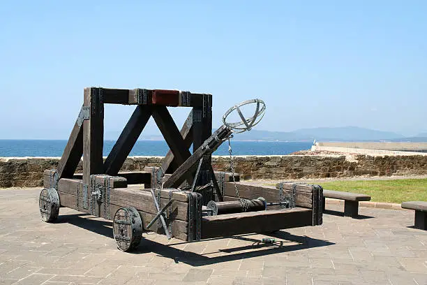 A medieval type catapult seige machine on the fortified city walls of Alghero on the Italian Island of Sardinia.