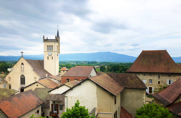 istock Morestel, France: Church and Clock Tower, Surrounding Village Rooftops 1538687525