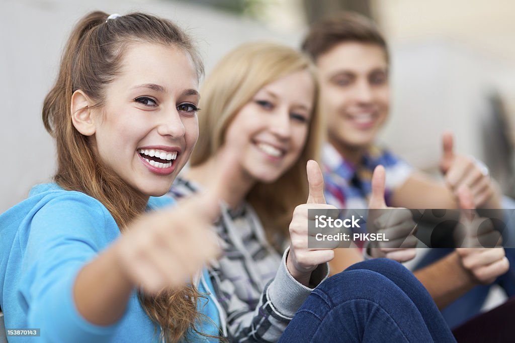 Three friends with thumbs up Adult Stock Photo