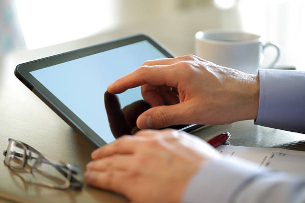 istock Finger touching screen of a digital tablet 153870480