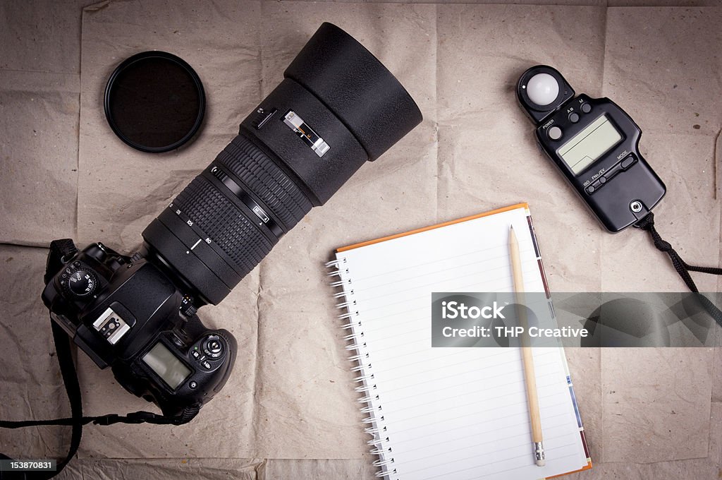 Photography Camera Background Photography equipment including a professional digital SLR camera and light meter with a blank notebook Backgrounds Stock Photo