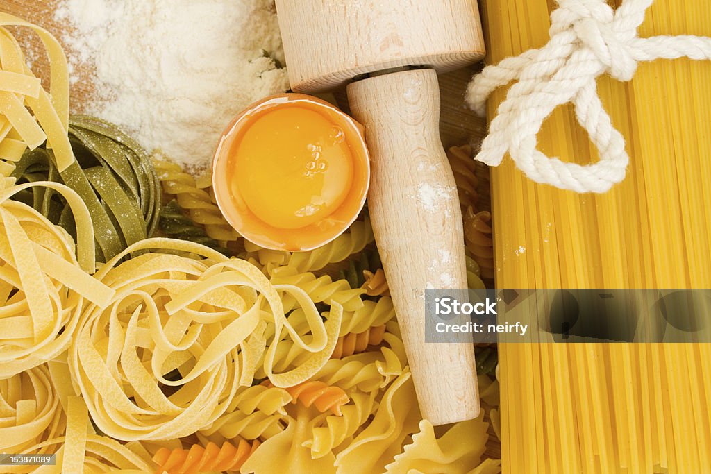 Making homemade pasta Making homemade pasta with a wooden roller Backgrounds Stock Photo