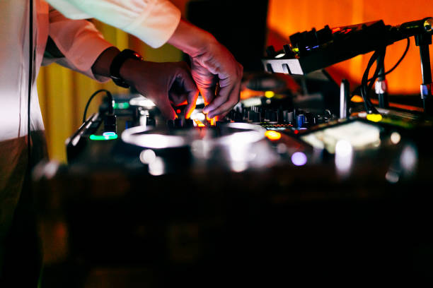 DJ is playing music in a nightclub