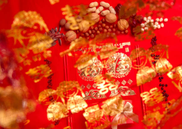 Nuts and red envelopes on a red tabletop, bokeh foreground, festive pictures of oriental countries, pictures of weddings and happy events(Translation: "Fu" is a symbol of auspiciousness and good luck in oriental countries) Nuts and red envelopes on a red tabletop, bokeh foreground, festive pictures of oriental countries, pictures of weddings and happy events(Translation: "Fu" is a symbol of auspiciousness and good luck in oriental countries). canadian coin stock pictures, royalty-free photos & images