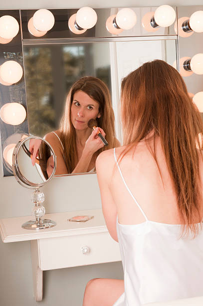 istock Young Woman Applying blush  Make-Up Mirror 153874187