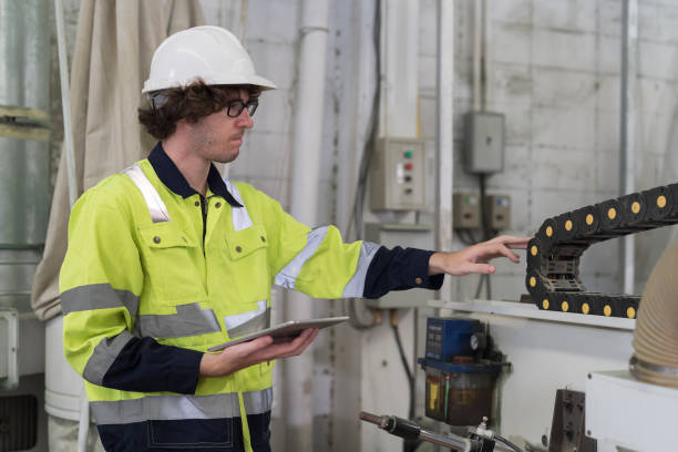 istock Male engineer worker checking conveyor belt machine at the industry factory. Male technician wear safety uniform working maintaining machine in the factory 1538756380