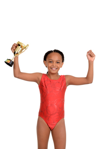isolated Young girl with gymnastics trophy