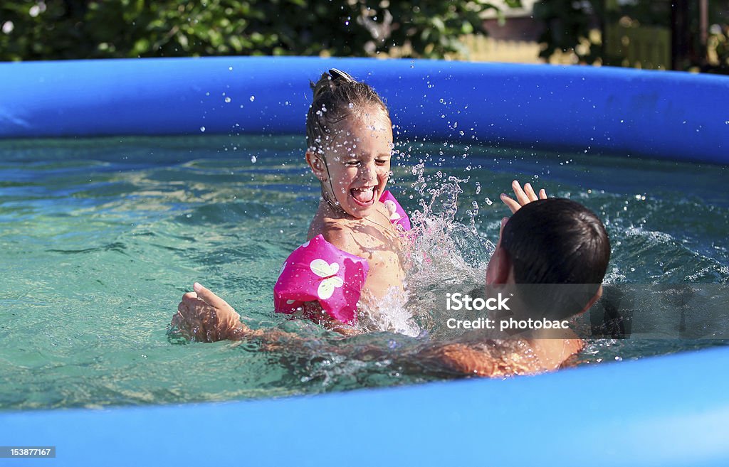 Dicteren rekenkundig of Kids Having Fun In The Swimming Pool Stock Photo - Download Image Now - Inflatable  Swimming Pool, Children's Pool, Inflatable - iStock