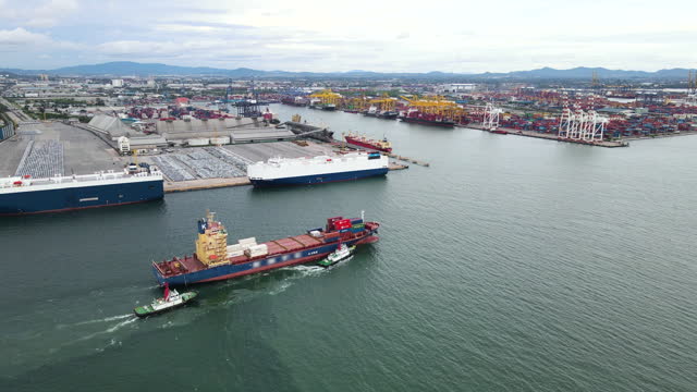 Aerial View Of Export Cargo Container Ship Cruising With  Commercial Port Background