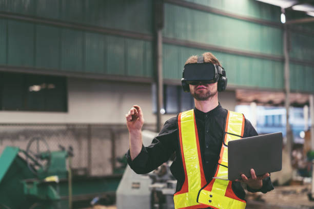 istock Male factory mechanic using virtual reality headset. Male engineer working or using virtual reality headset for checking machinery in industry factory and wearing safety uniform and helmet 1538809108