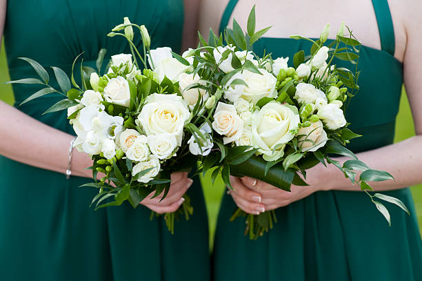 istock bridesmaids hold flowers 153881704