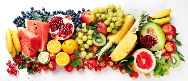 Fresh fruits, assorted fruits on a white background. Vitamins natural nutrition concept. Panorama.