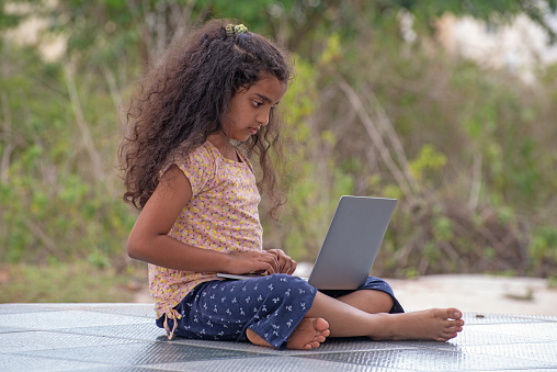 Indian elementary school enjoy working on desk top computer