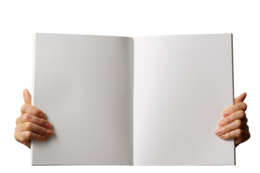 Holding a blank book for your copy text against white background with clipping path.