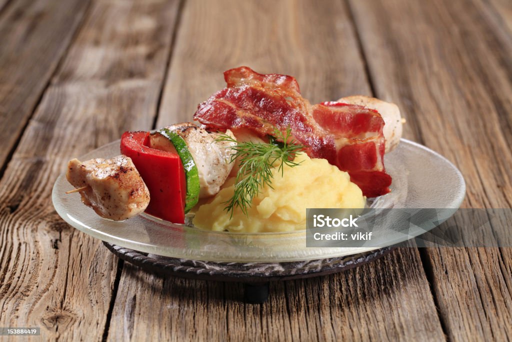 Chicken shish kebab and mashed potato Chicken shish kebab with mashed potato and rasher of bacon Bacon Stock Photo