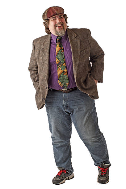Large man laughs and stands with hands in pockets
