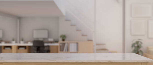 istock Empty space on a white marble tabletop with a blurred, minimal white home working room 1538877749
