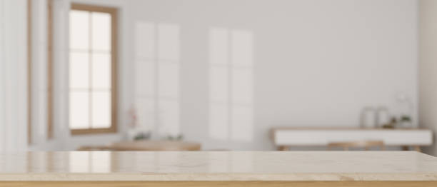 istock Empty space on a tabletop with a blurred, minimal, white living room as a background. 1538877751