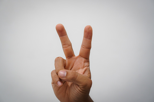 Man`s hand gesture, counting number Two, isolated on white background - part of set