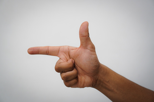 Palm of a male hand showing five fingers pointing up. On blue background.