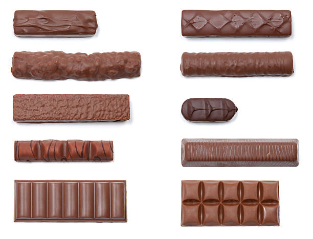 Chocolate Candy I Ten chocolate bars shot from an overhead angle isolated on white. chocolate bar photos stock pictures, royalty-free photos & images