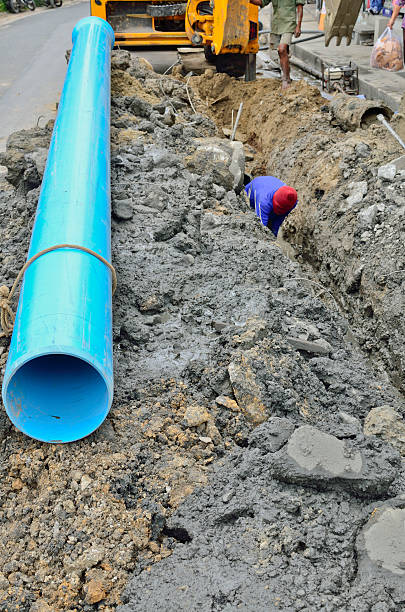 istock man digging trench for water supply 153889354