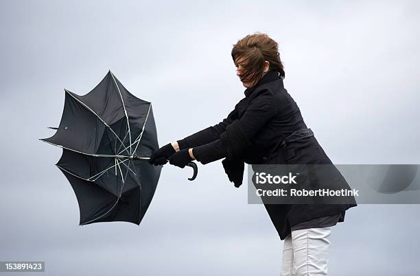 Fighting Against The Wind Stock Photo - Download Image Now - Storm, Umbrella, Wind