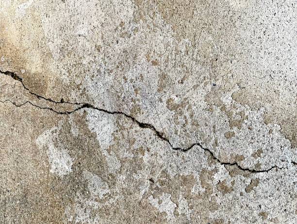 istock nailing on a concrete surface with a crack in the middle. 1538917438
