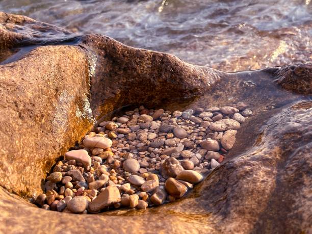 istock Sea beach pebbles in stone. 1538951016